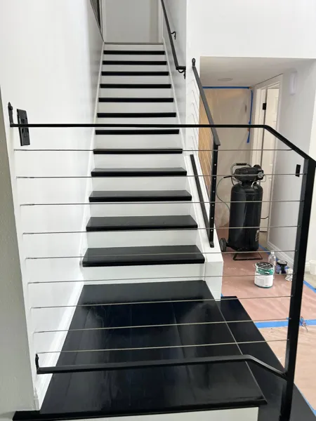 AJM Construction Services: black-and-white staircase with cable railing, interior remodel in the Inland Empire