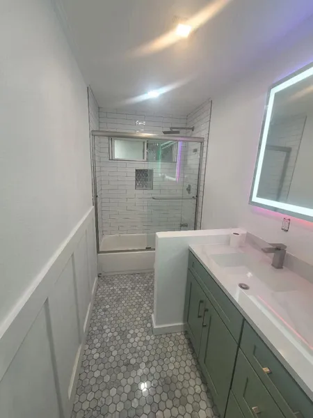 AJM Construction Services: bathroom remodel with vanity and frameless glass shower in the Inland Empire