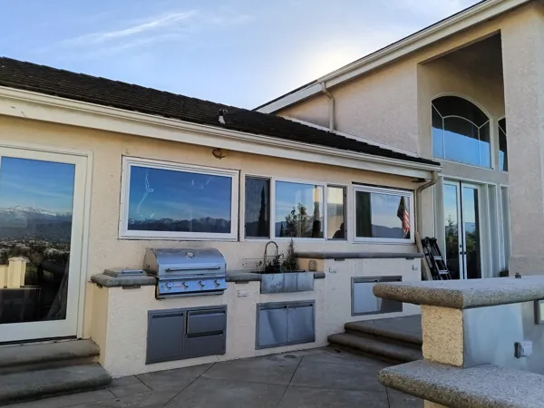 AJM Construction Services: outdoor BBQ kitchen with built-in grill, sink and stainless storage doors